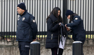 Policemen search a woman outside the United States embassy in Ankara. (AFP file photo)