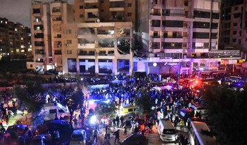 People gather at the site of a strike, reported by Lebanese media to be an Israeli strike targeting a Hamas office.