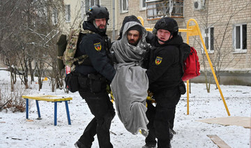 Ukraininan Police officers carry a local resident injured as a result of a missile attack in Kharkiv on January 23, 2024. (AFP)