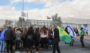 Israeli demonstrators gather by the border fence with Egypt at the Nitzana border crossing in southern Israel.