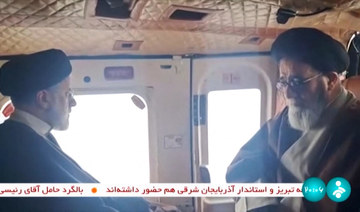 Video footage shows Iran's President Ebrahim Raisi (L) with an unidentified memeber of his delegation on board a helicopter.