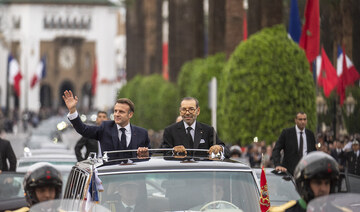 Morocco’s king Mohammed VI and French president Emmanuel Macron wave to crowds during the latter’s visit to Morocco, in Rabat.