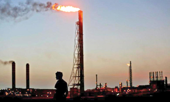 Oil rises on weak dollar, Saudi commitment to cut output