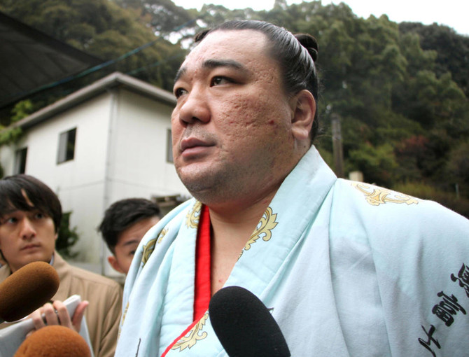 Mongolian sumo champ apologizes after media reports beer bottle assault on fellow wrestler