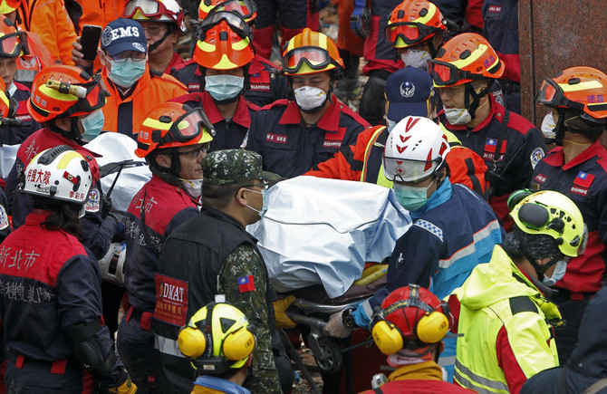 Workers try to shore up tilted buildings after Taiwan quake