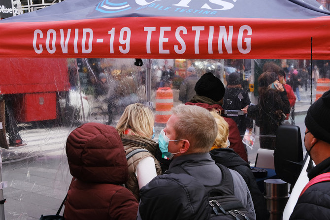 People wait in line to get tested for COVID-19 at a testing facility in Times Square on December 9, 2021 in New York City. (AFP)