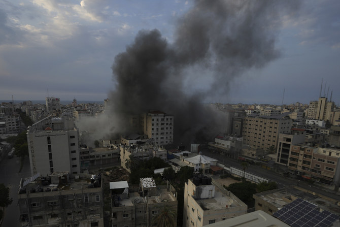 Smoke rises from an explosion on the Islamic National Bank following an Israeli air strike in Gaza City, Sunday, Oct. 8, 2023. (AP)