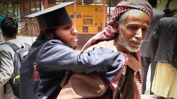 Images of a father carrying his disabled son during graduation in Yemen tugs at the heart strings