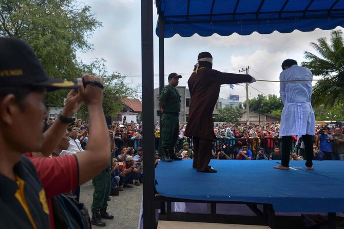 Couples whipped in Indonesia’s Aceh for public show of affection
