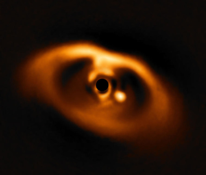 Astronomers report first image of baby planet being formed