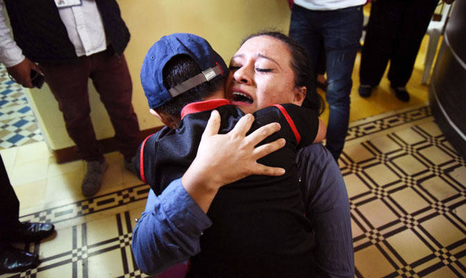 Tearful reunions for 9 separated kids back in Guatemala