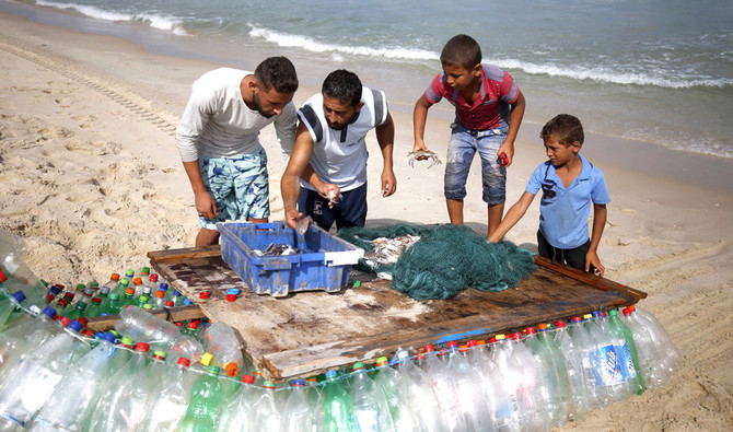 Gaza fisherman battles poverty with plastic-bottle boat