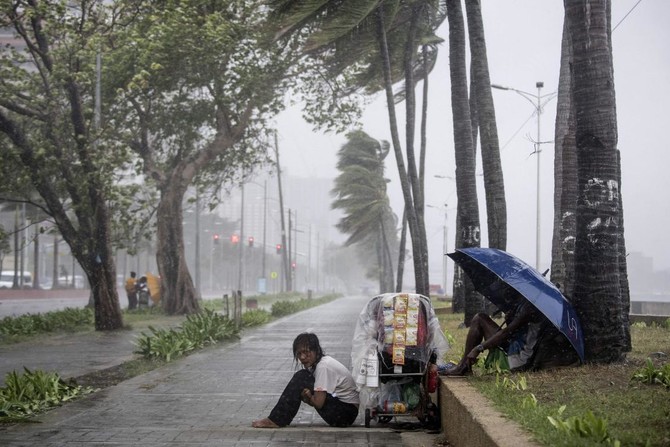 Philippines races to free 30 trapped in landslide; typhoon kills 7