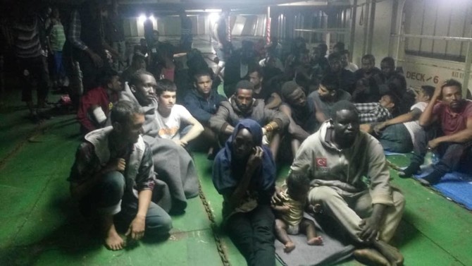Dozens of migrants refuse to leave container ship in Libya