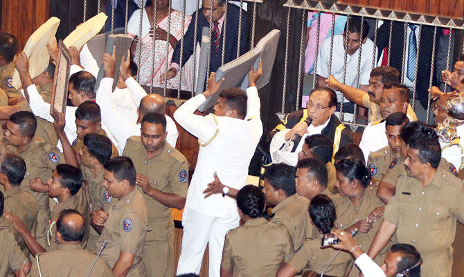 Bottles, chili paste thrown as Sri Lanka parliament descends into farce