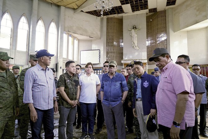 Abu Sayyaf commander among suspects in Philippine church attack; Duterte visits blast site
