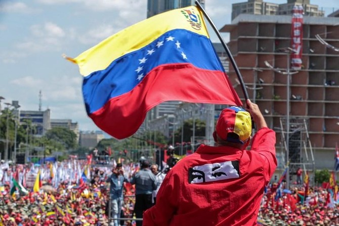 Venezuelans rally for and against embattled Maduro on revolution anniversary