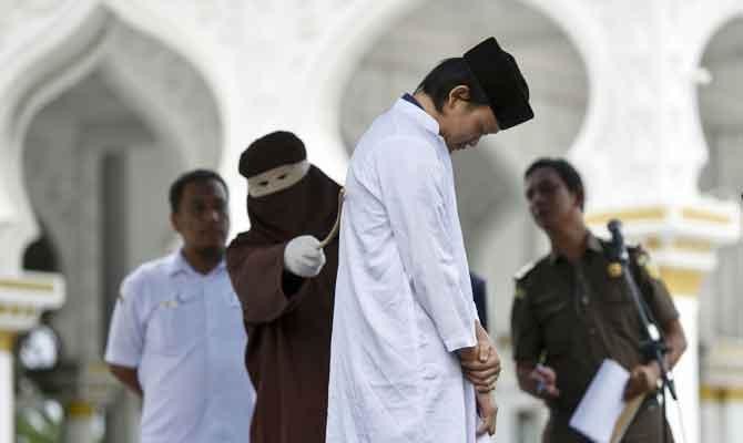 Indonesia’s Aceh whips unmarried couples after hotel raid