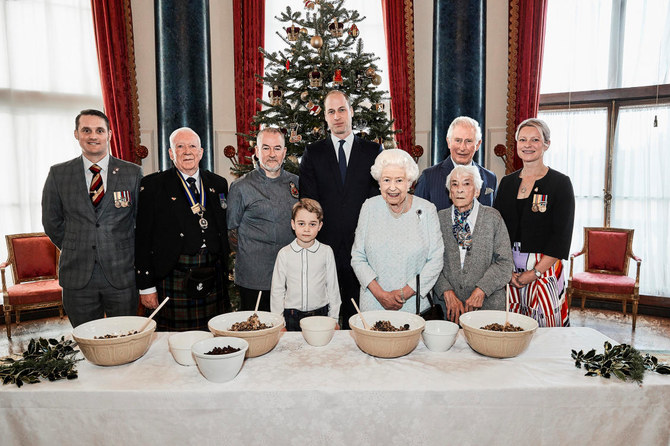 Queen Elizabeth mixes puddings, and sends message of continuity