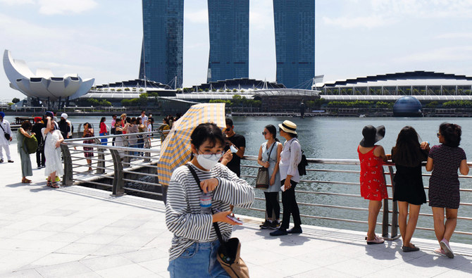 Singapore lowers growth forecast as virus hits economy