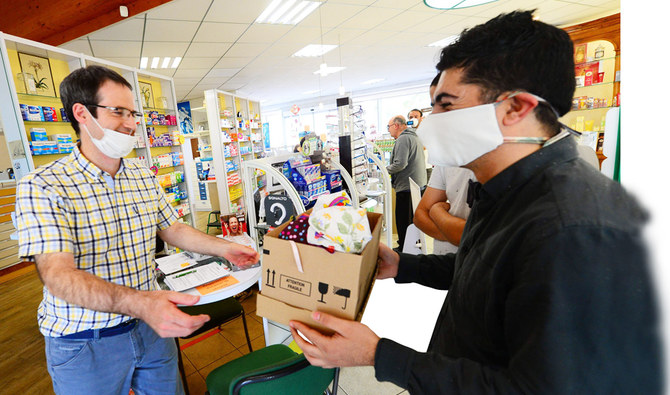 Face masks help Syrian Kurd refugee family integrate in France