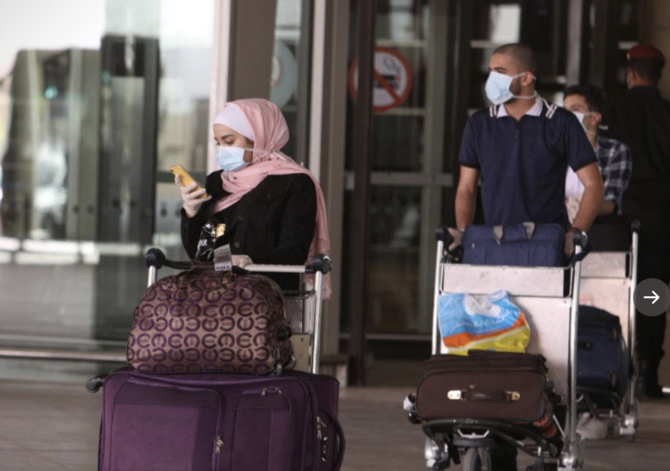 Jordan slaps wristbands on arrivals to monitor virus quarantine