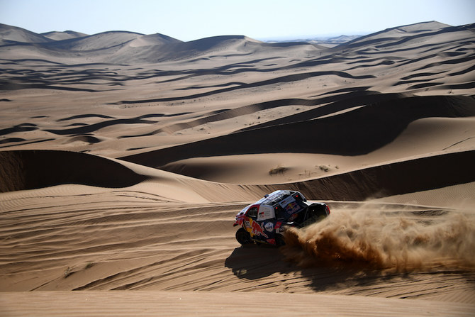 Nasser Al-Attiyah won a third consecutive stage of the Dakar Rally in Saudi Arabia and remained five minutes behind overall leader Stephane Peterhansel. (AFP)
