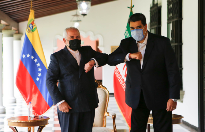 Handout picture released by Venezuelan Presidency showing Venezuela's President Nicolas Maduro (R) bumping elbows with the Foreign Minister of the Islamic Republic of Iran, Javad Zarif (L) at Miraflores Palace in Caracas, on November 5, 2020. (AFP/File Photo)