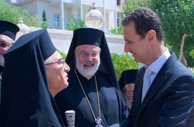 Syrian President Bashar Assad (R) meeting the new Melkite Greek Catholic Patriarch Youssef Absi (L) in the Syrian capital Damascus. (AFP/SANA/File Photo)