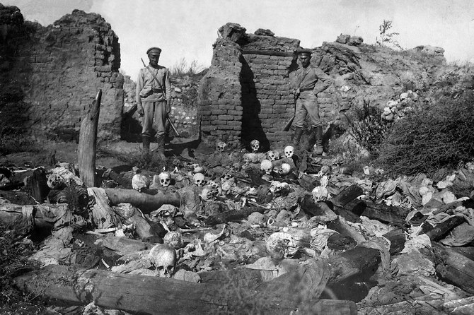 A picture released by the Armenian Genocide Museum-Institute dated 1915 purportedly shows soldiers standing over skulls of victims from the Armenian village of Sheyxalan in the Mush valley, on the Caucasus front during the First World War. (STR/AGMI/AFP)