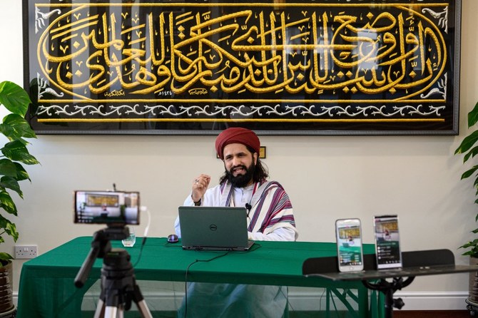 Imam Hassanat Ahmed delivers his Friday broadcast via multiple social media platforms from the otherwise empty Noor Ul Islam Mosque in Bury, Manchester, UK. (AFP)