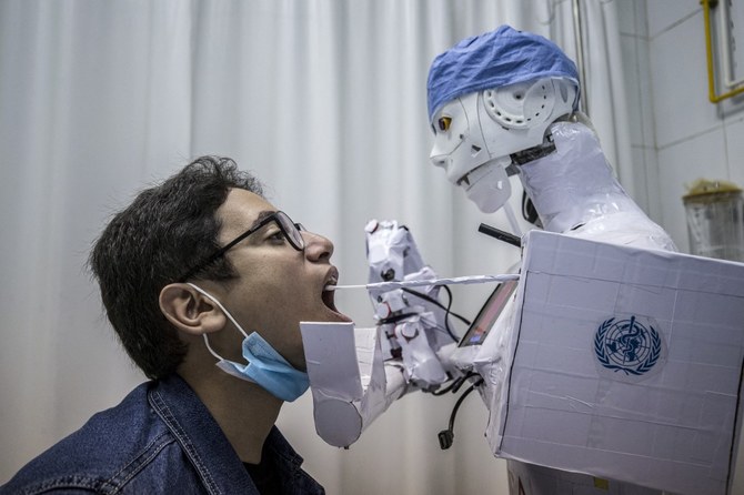 A prong extending from the CIRA-03 remote-controlled robot prototype approaches the mouth of a volunteer at a private hospital in Egypt's Nile delta city of Tanta. (AFP/File Photo)