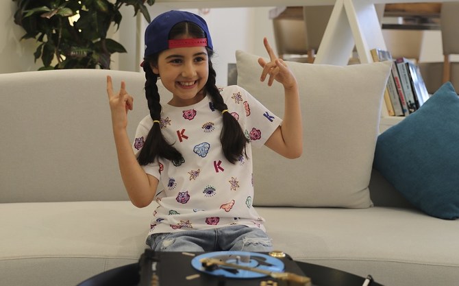 Michelle Rasul flashes a rockstar sign in the lobby of her apartment building in Dubai, United Arab Emirates, Sunday, May 9, 2021. (AP)