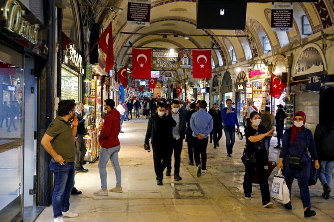 People wearing protective face masks walk at the Grand Bazaar as it reopens after weeks of closed doors amid the spread of the coronavirus in Istanbul (Reuters/File Photo)