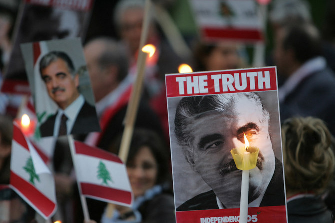 Pictures of slain former Lebanese premier Rafiq Hariri, national flags and lighting candles are seen during a demonstration held by some 200 lebanese protesters in downtown Athens. (AFP/File Photo)