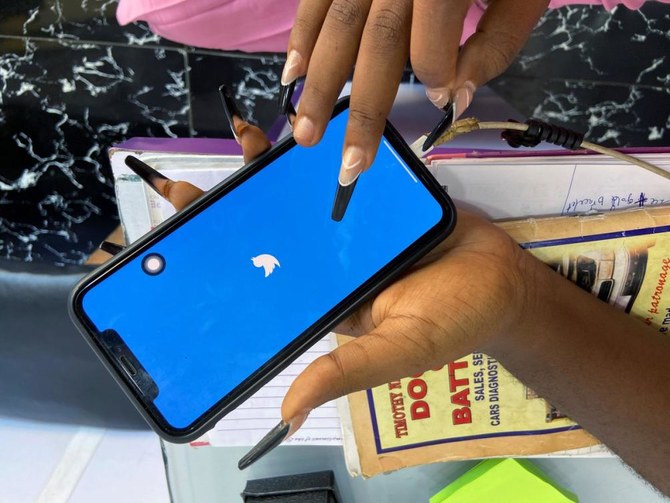 Lagos based entreprenuer Ogechi Egemonu opens the Twitter app on a smart phone at her office in Lagos. (Reuters)