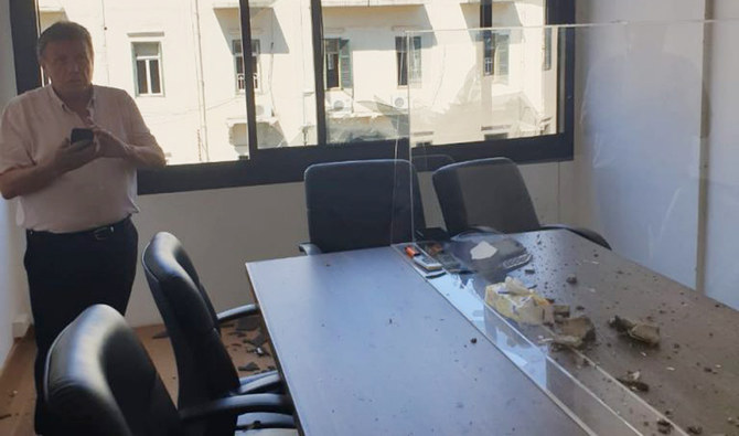 Sakher El-Hachem looks at the damages in his office after the explosion. (Supplied)