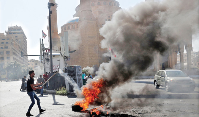 Demonstrators burn tires to block the Martyrs’ Square in Beirut. (AFP)