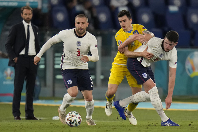 Ukraine’s Mykola Shaparenko, center, fights for the ball with England’s Declan Rice, right, and Luke Shaw during the Euro 2020 quarterfinal match between Ukraine and England at the Olympic stadium in Rome. (AP)