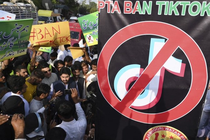 Activists of the Jamhoori Wattan Party carry placards during a protest to demand the ban of TikTok social media, in Lahore. (AFP)