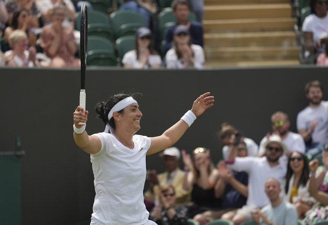 Tunisia's Ons Jabeur celebrates celebrates after defeating Poland's Iga Swiatek during the women's singles fourth round match on day seven of the Wimbledon Tennis Championships. (AP)