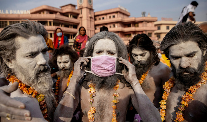A Hindu man wears a mask before the procession for taking a dip in the Ganges river during Shahi Snan at "Kumbh Mela" amidst the spread of the coronavirus disease (COVID-19), in Haridwar, India, April 12, 2021. (REUTERS)