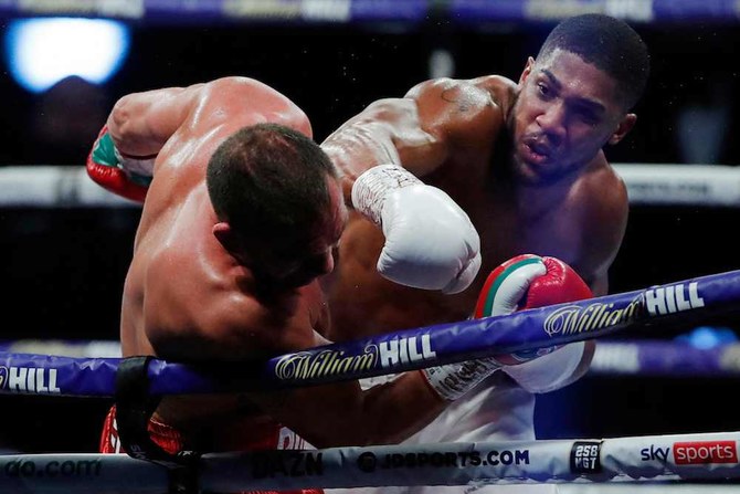 Anthony Joshua (R) lands a punch on Bulgaria's Kubrat Pulev (L) during their heavyweight world title boxing match at Wembley Arena in north west London on December 12, 2020. (AFP/File Photo)