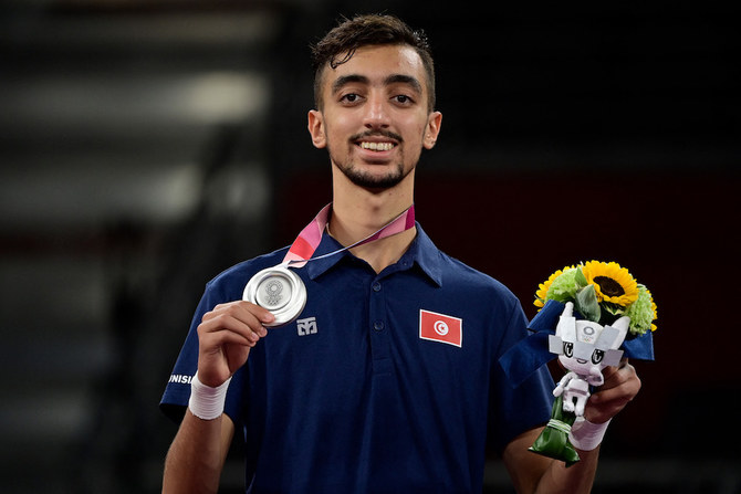 Tunisia's Mohamed Khalil Jendoubi won the first Arab medal at the Tokyo Olympics on Saturday - a silver in the Taekwondo competition. (AFP)