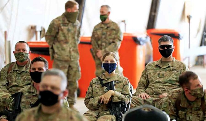 U.S. soldiers wearing protective masks are seen during a handover ceremony of Taji military base from US-led coalition troops to Iraqi security forces, in Baghdad, Iraq August 23, 2020. (REUTERS)
