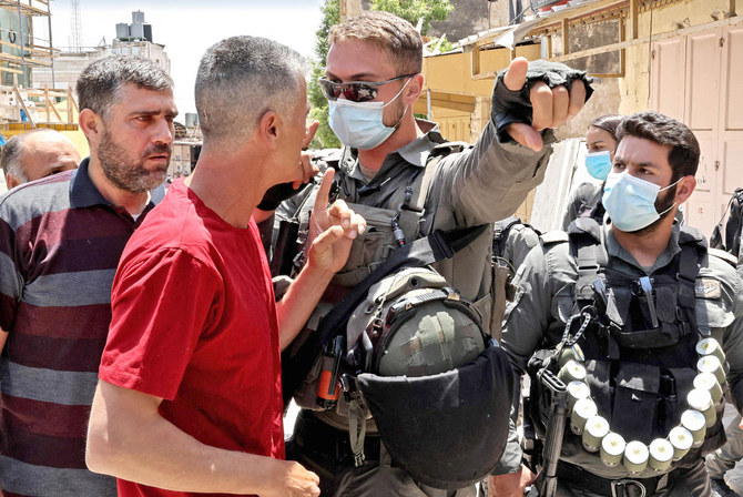 Israeli security forces argue with Palestinian worshippers during a demonstration in Hebron following Friday prayers at the Ibrahimi mosque. (AFP)