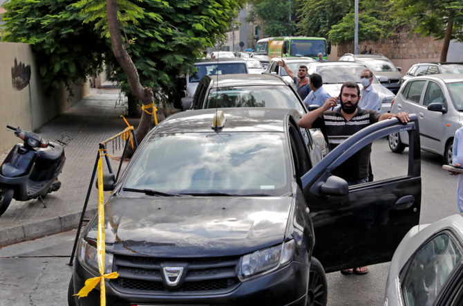 Lebanese wait in a queue at a closed petrol station in Beirut. The energy crisis is dragging people to unlikely places in their desperate quest for daily essentials. (AFP)