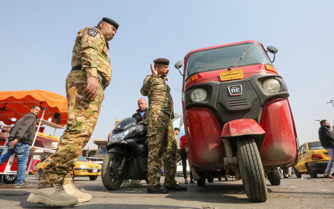  Iraqi police man search a vehicle at a checkpoint on the entrance of Baghdad's Tahrir Square. (AFP file photo)