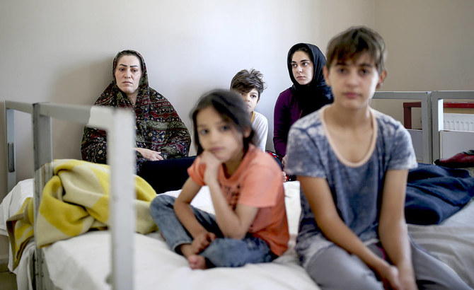 A migrant family at a deportation center in Turkish city of Van that borders Iran and Turkey. The country already hosts over 4 million Syrian refugees. (AP)