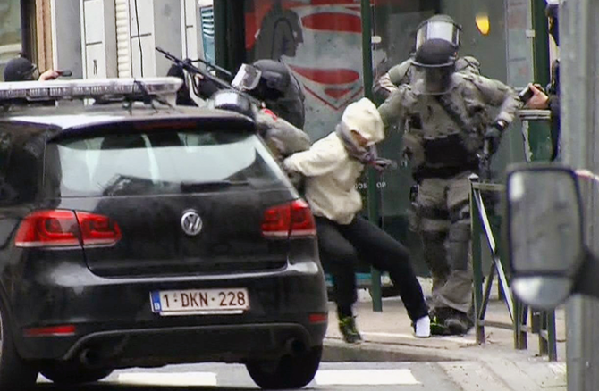 In this Friday March 18, 2016 file framegrab taken from VTM, Salah Abdeslam, centre, is arrested by police and bundled into a police vehicle during a raid in the Molenbeek neighborhood of Brussels, Belgium. (AP)